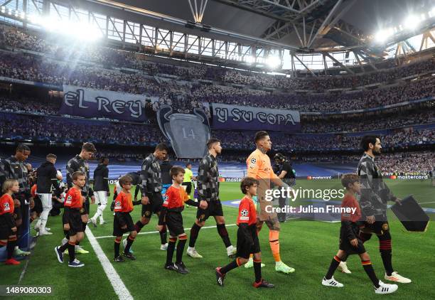 Manchester City and Real Madrid players enter the pitch before the UEFA Champions League semi-final first leg match between Real Madrid and...