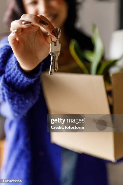 joyful young woman showing you house keys of the new home that she is moving into - house viewing stock pictures, royalty-free photos & images