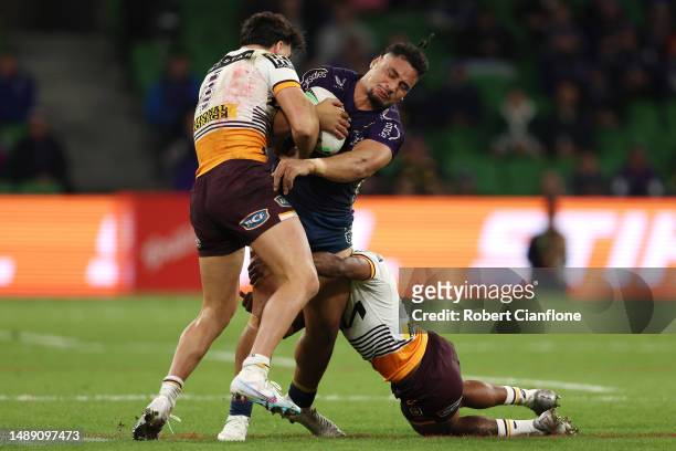 Eliesa Katoa of the Storm is tackled during the round 11 NRL match between Melbourne Storm and Brisbane Broncos at AAMI Park on May 11, 2023 in...