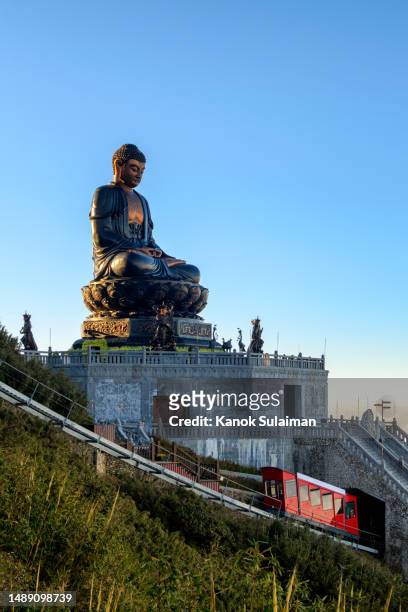 sunlight with scenic view misty mountain kim son bao thang tu pagoda , chinese god u lai on fansipan mountain in sa pa, vietnam - giant buddha stock pictures, royalty-free photos & images