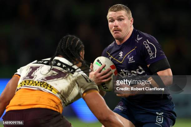 Josh King of the Storm is tackled during the round 11 NRL match between Melbourne Storm and Brisbane Broncos at AAMI Park on May 11, 2023 in...