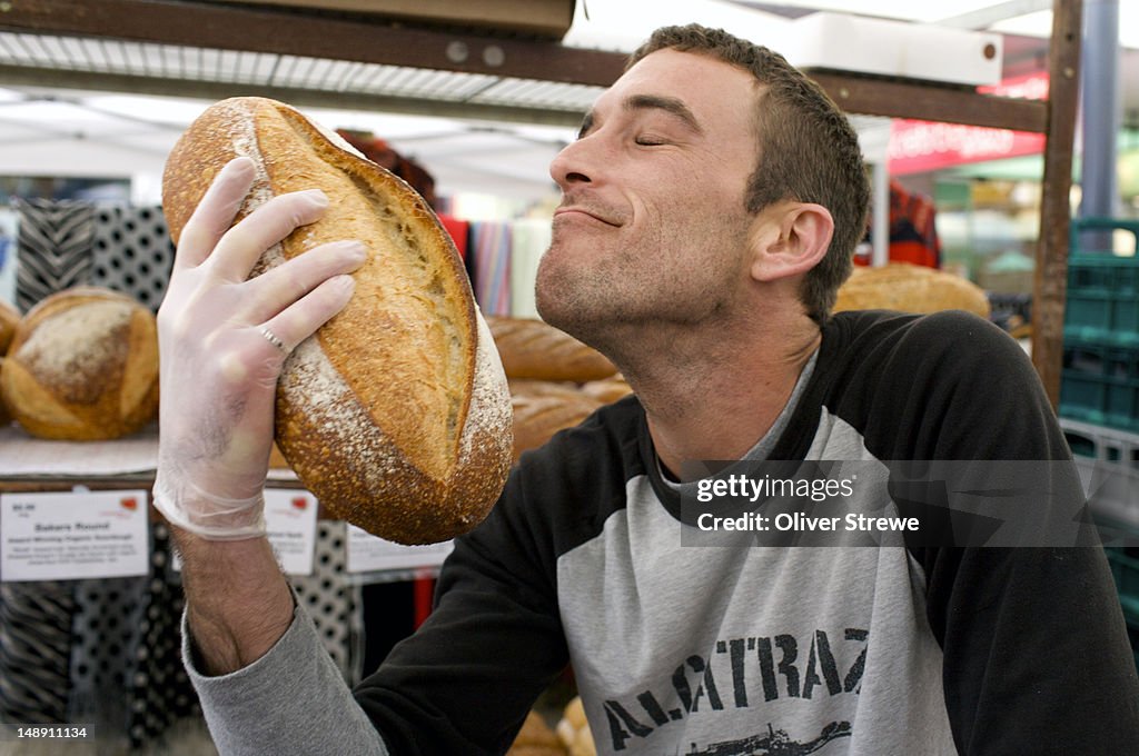 Baker smelling bread at Bondi Junction market.