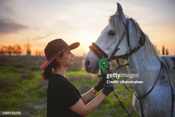 happy girl playing with animals in corral ranch - human and animals relationship concept - animal riding stockfoto's en -beelden