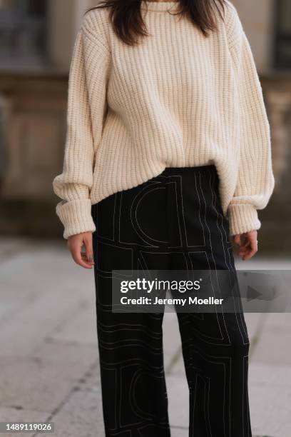 Elise Seitz seen wearing Birkenstock beige olive shoes, Toteme black pants, Soho Studios white knit sweater, Chanel black leather handbag, Bottega...