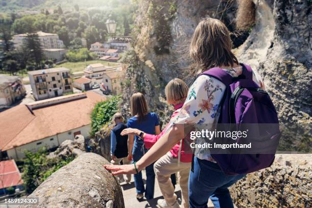 multi generation family walking down the stairs in small calabrian town of tropea - calabria stock pictures, royalty-free photos & images