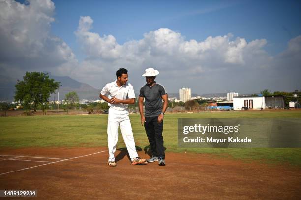 cricket captain taking last minute advice from the coach standing on the pitch - cricket stock pictures, royalty-free photos & images
