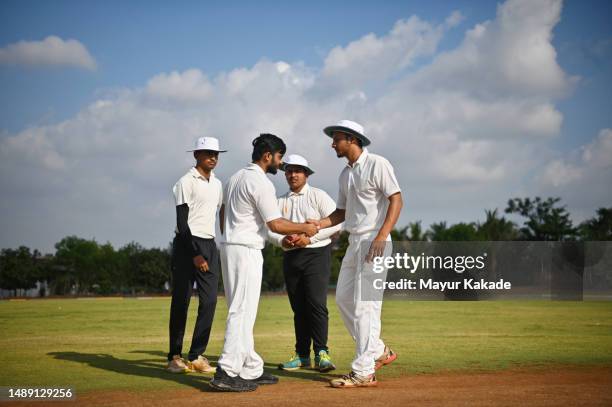 umpire presiding over the coin toss before the start of a cricket match - cricket team stock pictures, royalty-free photos & images