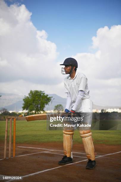 cricket batsman on the field, warming up before the match - sports india stock pictures, royalty-free photos & images