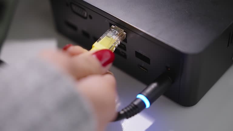 Pluggin A Computer Plugging In Computer Videos and HD Footage - Getty Images