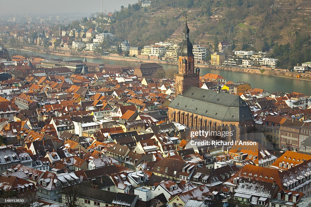 City rooftops and church in winter.