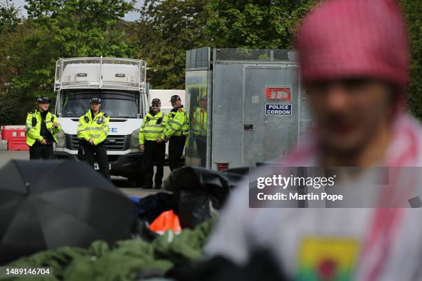 Protesters wake up after a night sleeping on the road outside UAV Tactical Systems watched by police officers on May 7, 2023 in Leicester, England....