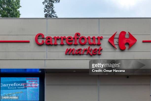 The logo of the major supermarket chain Carrefour is seen in one of its shopping facilities in the center of the commune of Uccle on May 11, 2023 in...