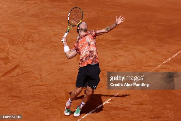 Marco Cecchinato of Italy serves against Mackenzie McDonald of the United States during the Men's Singles First Round match on Day Four at Foro...