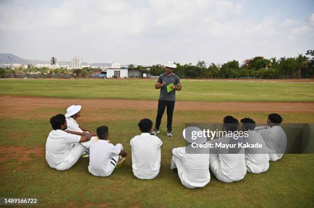 coach discussing strategy with his team during the innings break of a cricket match - indian society and daily life ストックフォトと画像