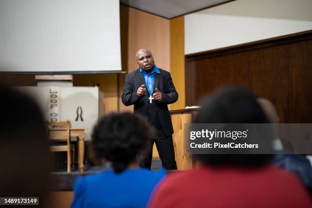 over shoulder view pastor preaching - pastor stock pictures, royalty-free photos & images