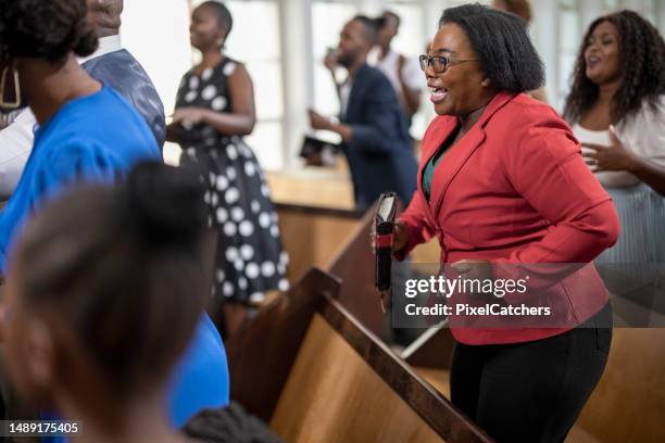 woman dancing and singing gospel music in church - female gospel singers stock pictures, royalty-free photos & images