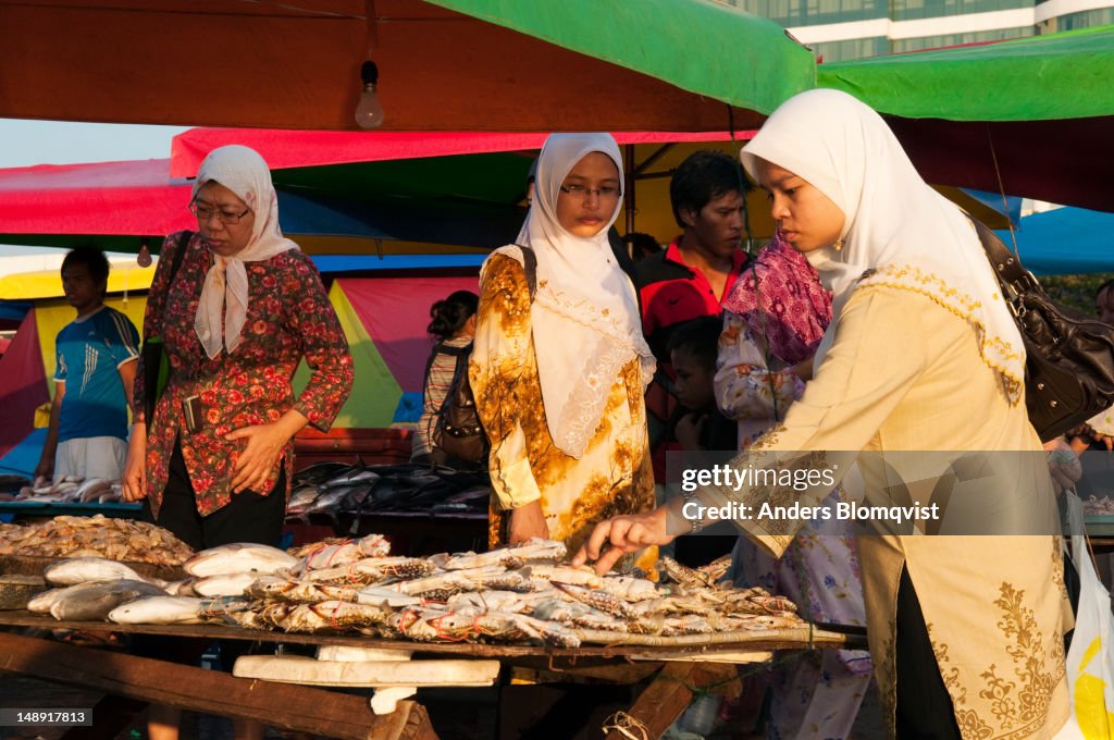 Women buying seafood at Night Market.