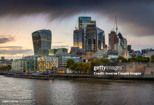 scene of city of london building group, modern financial glass office building riverbank at twilight time in down town district, london - mergr stock pictures, royalty-free photos & images