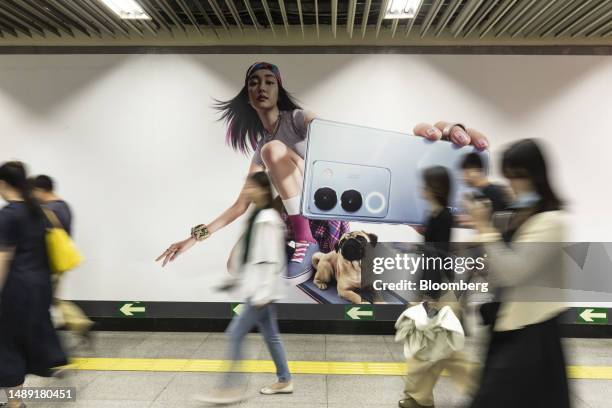 Commuters walk through the Guomao Subway station in Beijing, China, on Tuesday, July 4, 2023. Beijing has rolled out a raft of measures to prop up...