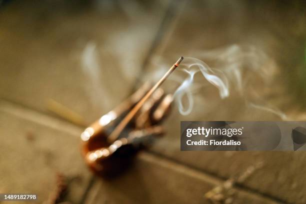 incense, perfumed burning sticks, candle. ritual attributes of a mystical spiritual seance - sandalwood fotografías e imágenes de stock