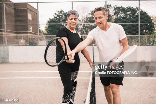 disabled latin woman practice tennis with coach - coaches clinic stock pictures, royalty-free photos & images