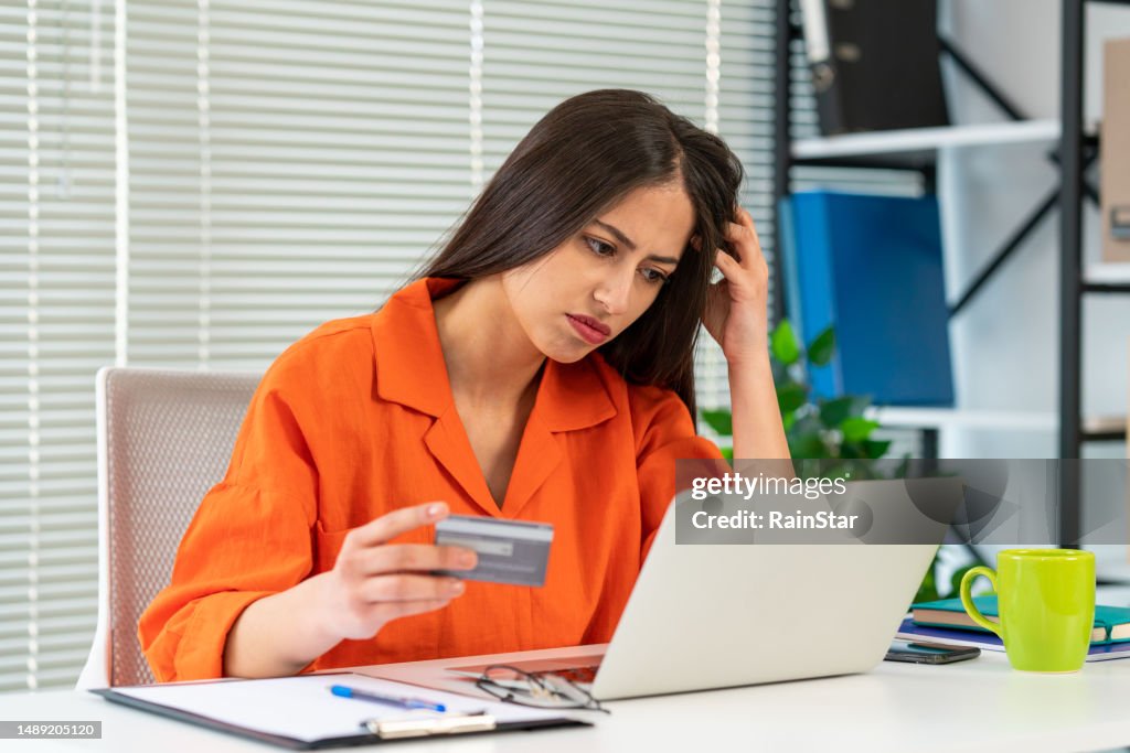 Financial problems, unsuccessful online shopping. Shocked woman with laptop and credit card