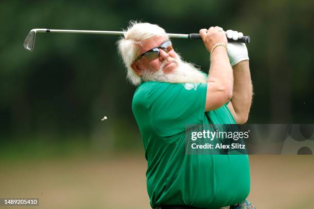 John Daly of the United States hits a tee shot on the fourth hole during the first round of the Regions Tradition at Greystone Golf and Country Club...