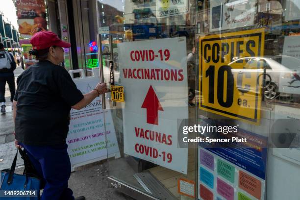 Pharmacy advertises Covid-19 vaccines in a window along Roosevelt Avenue, which passes through the neighborhoods of Elmhurst, Corona and Jackson...