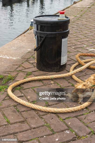 black barrel with high quality hydraulic oil stands on the quay near the port - oil drum stock pictures, royalty-free photos & images