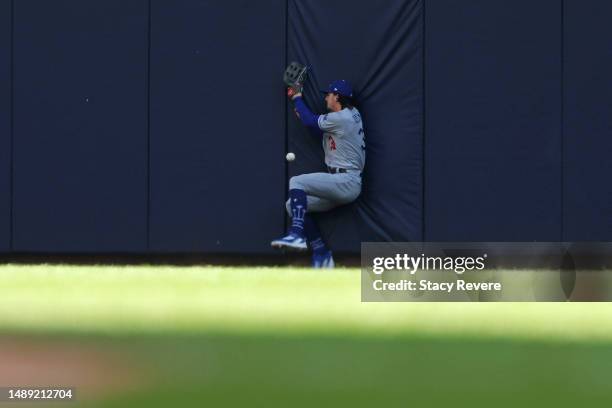 James Outman of the Los Angeles Dodgers is unable to field a fly ball during the fifth inning against the Milwaukee Brewers at American Family Field...