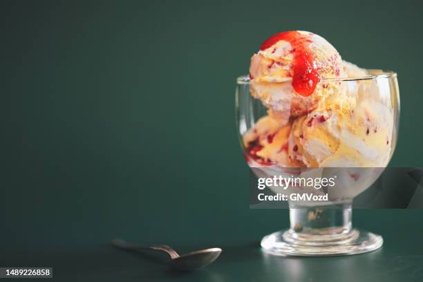 vanilla ice cream with strawberry topping - strawberry syrup stock pictures, royalty-free photos & images