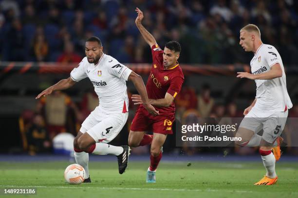 Jonathan Tah of Bayer 04 Leverkusen runs with the ball whilst under pressure from Zeki Celik of AS Roma during the UEFA Europa League semi-final...