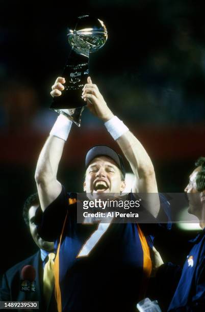 Quarterback John Elway of the Denver Broncos hoists up the Vince Lombardi Trophy after the Broncos defeated the Green Bay Packers in Super Bowl XXXII...