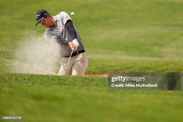 Dylan Frittelli of South Africa plays a shot from a fairway bunker on the ninth hole during the first round of the AT&T Byron Nelson at TPC Craig...