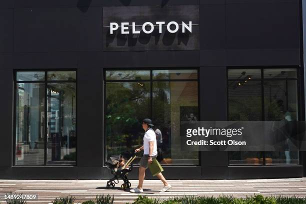 Shopper walks past a Peloton store in a shopping mall on May 11, 2023 in Oak Park, Illinois. The exercise equipment maker said it is recalling more...