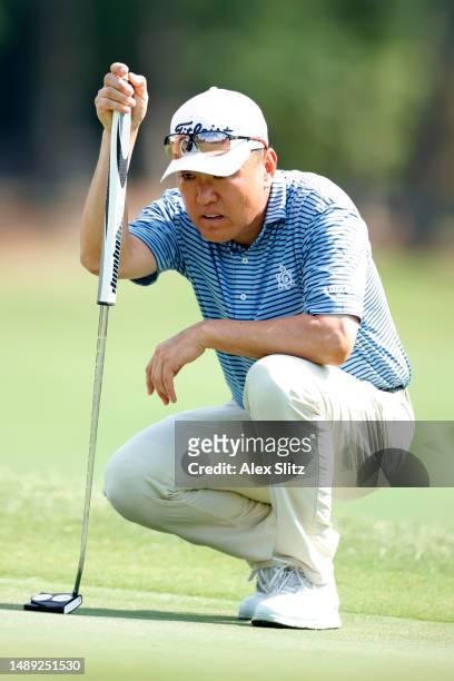 Charlie Wi of South Korea lines up a putt on the eighth green during the first round of the Regions Tradition at Greystone Golf and Country Club on...