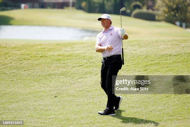 Retief Goosen of South Africa plays shot on the ninth fairway during the first round of the Regions Tradition at Greystone Golf and Country Club on...