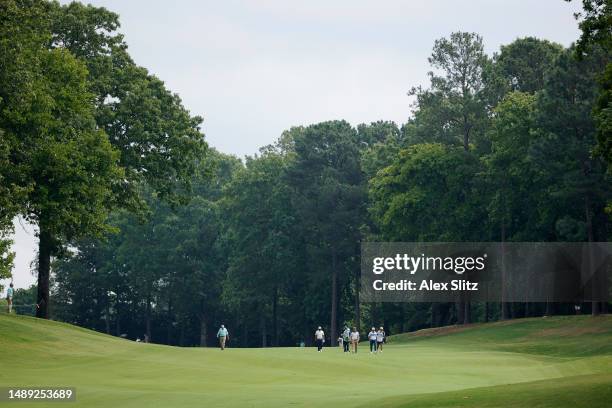 Bernhard Langer of Germany, Alex Cejka of Germany and Thongchai Jaidee of Thailand walk across the second fairway during the first round of the...