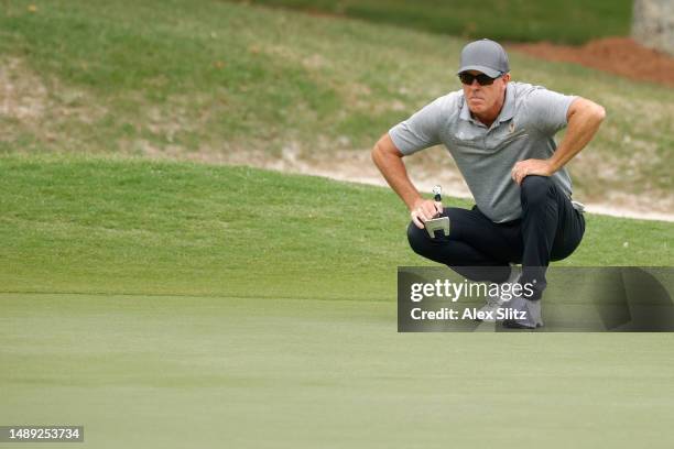 Richard Green of Australia lines up a putt on the third green during the first round of the Regions Tradition at Greystone Golf and Country Club on...