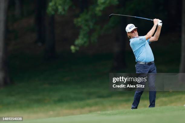 Miguel Angel Jimenez of Spain watches his shot on the 18th fairway during the first round of the Regions Tradition at Greystone Golf and Country Club...