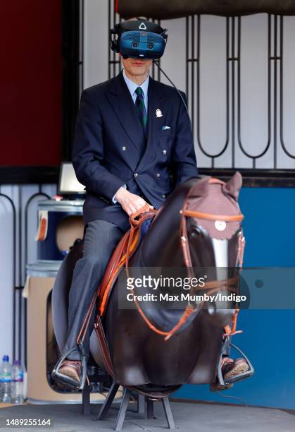 Prince Edward, Duke of Edinburgh tries a virtual reality horse racing simulator as he attends day 1 of the 2023 Royal Windsor Horse Show in Home...