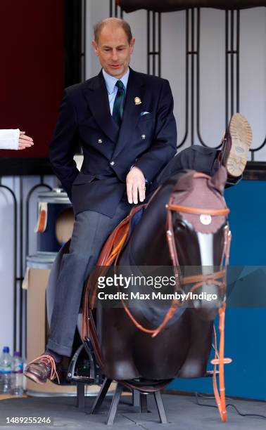 Prince Edward, Duke of Edinburgh dismounts after trying a virtual reality horse racing simulator as he attends day 1 of the 2023 Royal Windsor Horse...