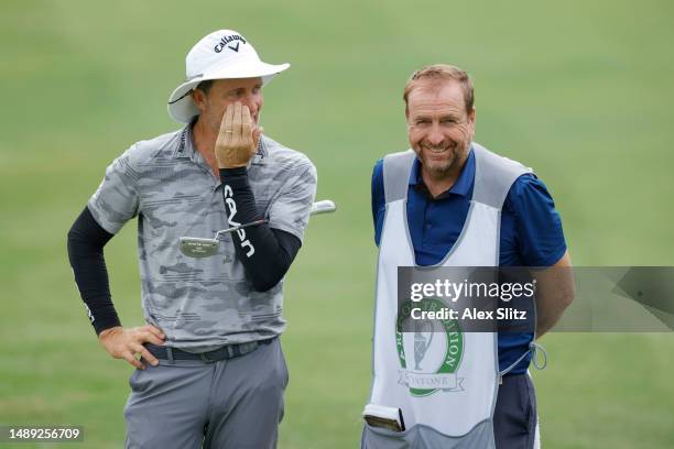 Stuart Appleby of Australia jokes with a caddie on the ninth hole during the first round of the Regions Tradition at Greystone Golf and Country Club...