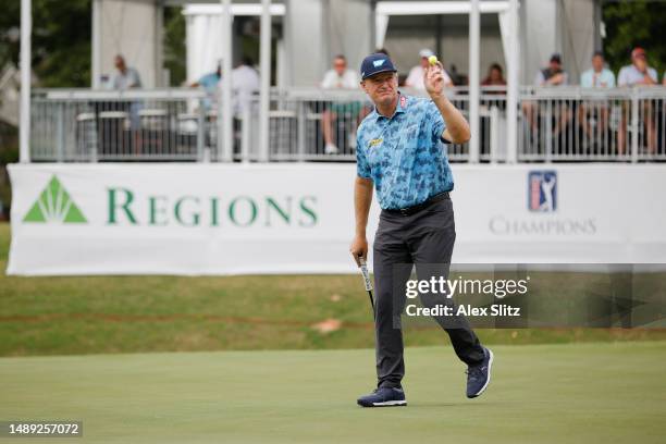 Ernie Els of South Africa reacts after a birdie putt on the 18th hole during the first round of the Regions Tradition at Greystone Golf and Country...