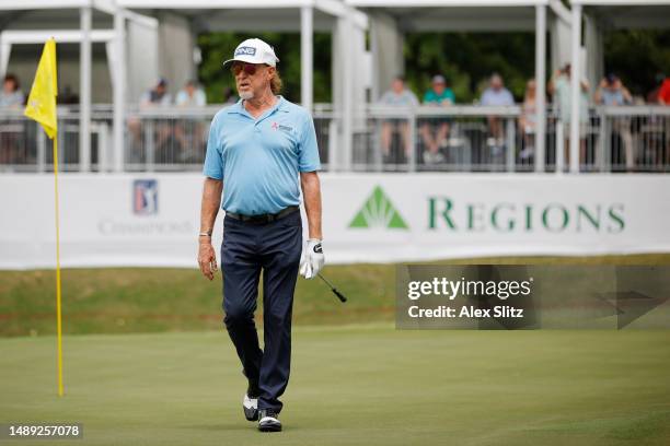 Miguel Angel Jimenez of Spain walks across the 18th green during the first round of the Regions Tradition at Greystone Golf and Country Club on May...