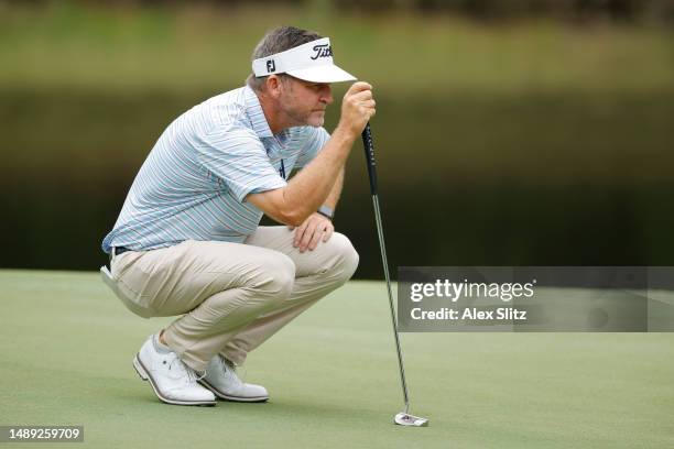 Jason Bohn of the United States lines up a putt on the second hole during the first round of the Regions Tradition at Greystone Golf and Country Club...