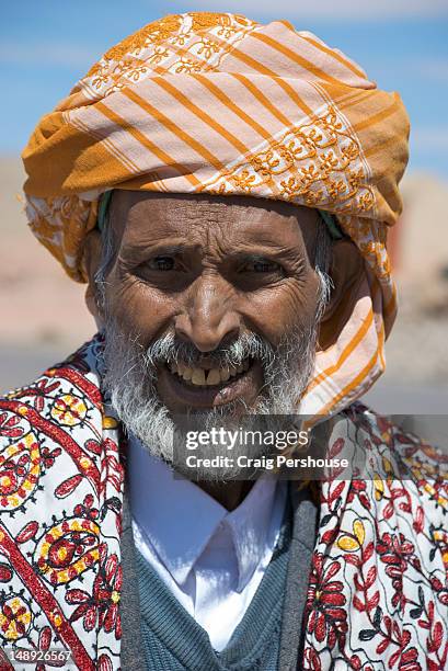 portrait of man in orange keffiyeh (headscarf). - yemen people stock pictures, royalty-free photos & images