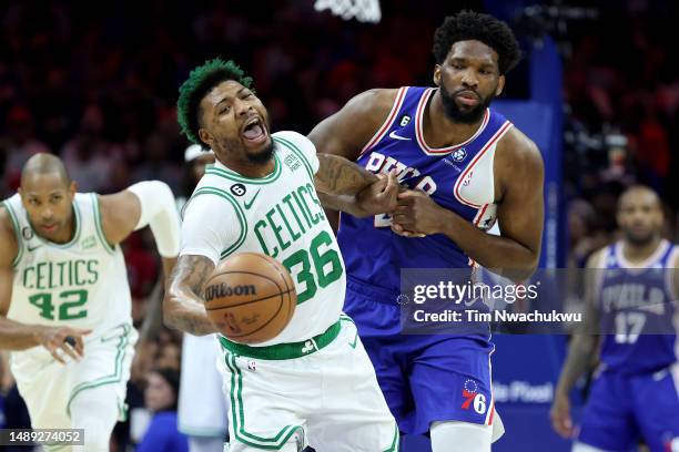 Marcus Smart of the Boston Celtics battles for the ball against Joel Embiid of the Philadelphia 76ers during the first quarter in game six of the...