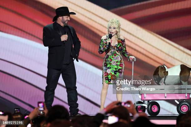 Co-host Garth Brooks and Dolly Parton speak onstage during the 58th Academy Of Country Music Awards at The Ford Center at The Star on May 11, 2023 in...