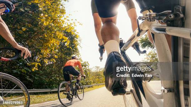 point of view male chinese cyclist competing in sports race cycling event at rural scene - peloton road cycling stock pictures, royalty-free photos & images